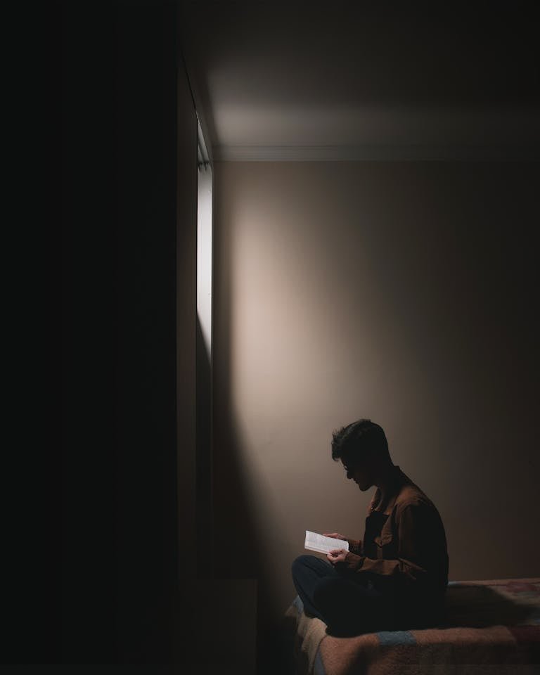 Man reading Scripture by window light representing the Great Awakening to biblical truth