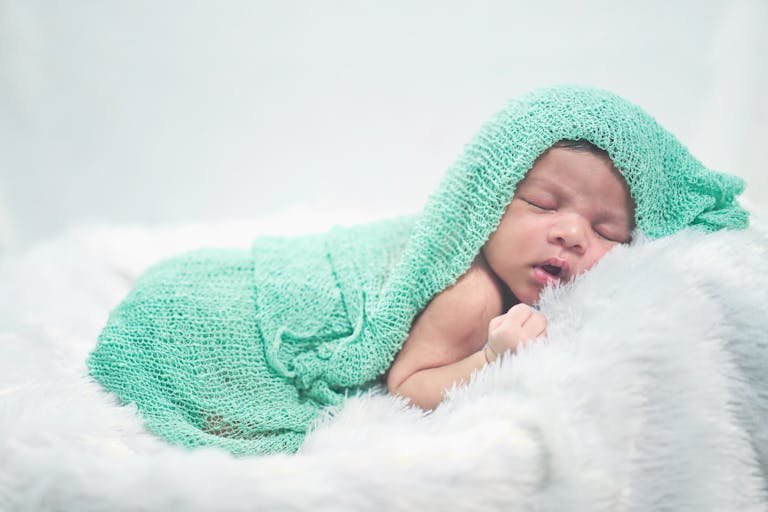 Serene image of a newborn baby wrapped in a soft depicting New birth in Christ