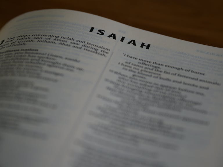 A detailed close-up of the Book of Isaiah in the Bible highlighting scripture text.